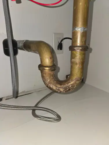 Corroded pipe under sink before replacement — Woodbridge